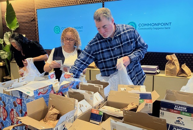 Volunteers packing food give-away bags at Commonpoint Queens